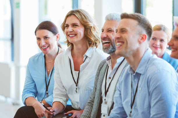 istock Group of excited people at business conference 1807980708