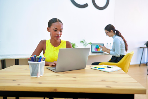The girl works as a freelancer in a digital marketing company in a modern environment such as a co-working where she can collaborate with other professionals.