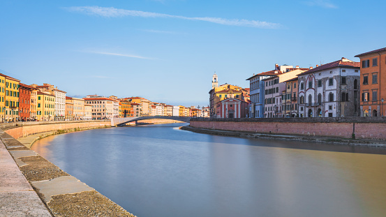 Pisa city, Arno river, Ponte di Mezzo bridge. Lungarno view. Tuscany region, Italy, Europe. Long exposure photograph