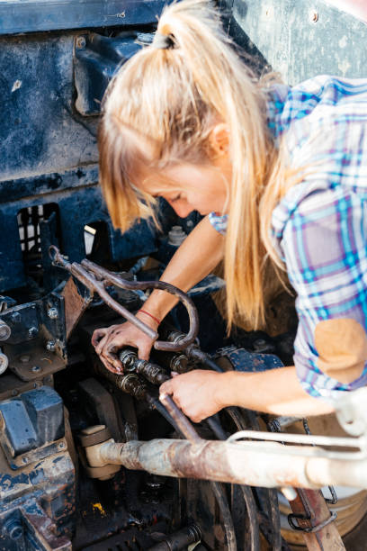 istock Focused farmer connecting machinery on a tractor in countryside during daytime 1807992890