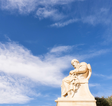 A full length side view of the statue of classical Greek philosopher Plato, located outside the Academy of Athens.