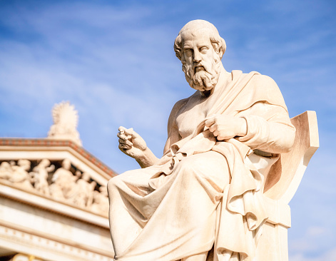 The marble statue of the ancient Greek philosopher Plato, with the front of the Academy of Athens in the background.\n\nThe statue was completed in 1885 by Leonidas Drosis.