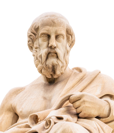 A close up of the statue of the classical Greek philosopher Plato, located outside the Academy of Athens, seen against a white background.\n\nThe statue was completed in 1885 by Leonidas Drosis.