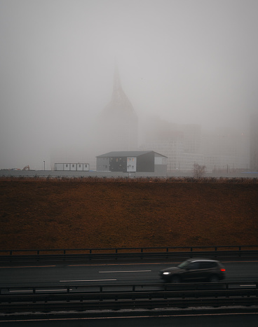 Motorway and houses in the fog in Saint-Petersburg