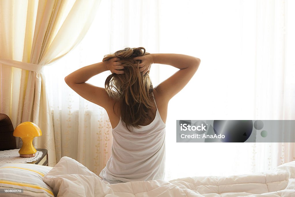 Rise and Shine Young woman waking up with a morning stretch. 20-29 Years Stock Photo