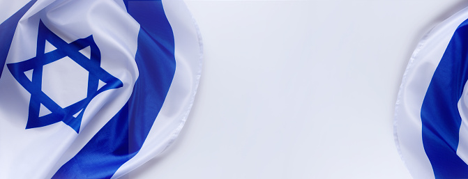 Banner with Official flag of Israel on a white background and empty space for text. Israeli flag for Jewish Holidays and independence day.