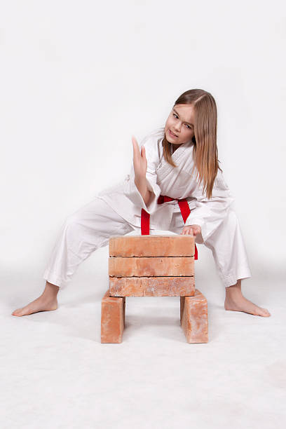 Karate girl breaks bricks 1 stock photo