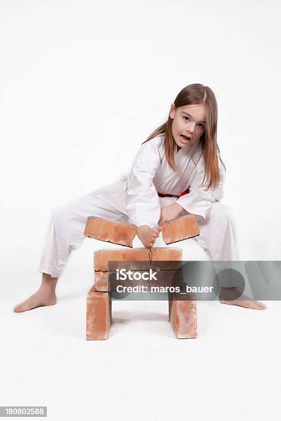 Karate Girl Breaks Bricks 2 Stock Photo - Download Image Now - Brick, Karate, Breaking