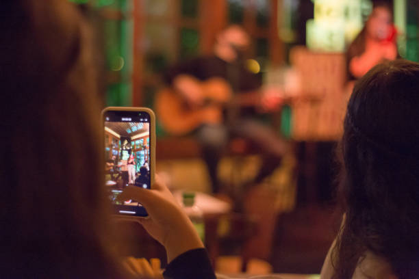 istock Young woman taking a selfie with her mobile phone in a pub 1808031948
