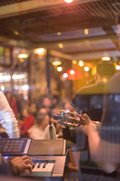 Blurred image of people in a pub with a musical instruments