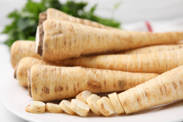 istock Whole and cut parsley roots on table, closeup 1808040553