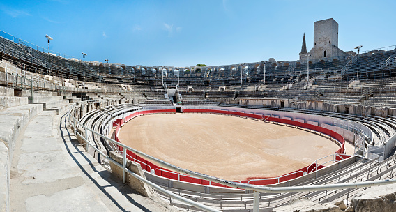 Roman ruins of an ampitheater used as a bullfighting and gaming arena, in Arles, France.  Arles is located in the Provence area of France.