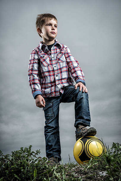 istock cute little boy with soccer ball 180804703