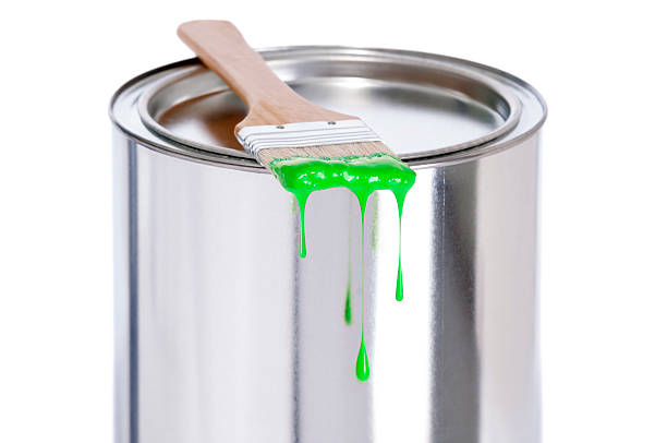 istock Green dripping Paint Brush on a tin of paint 180804873