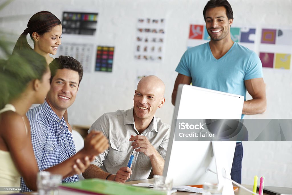 Coworkers making their contribution A group of smiling designers working together at a computer Adult Stock Photo