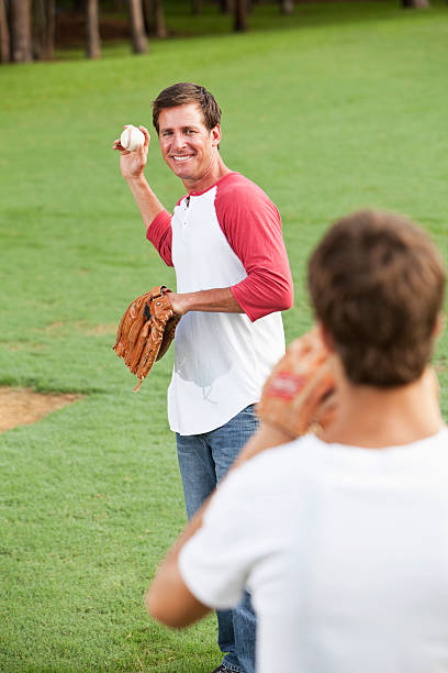 istock Father and teenage son playing baseball 180805281