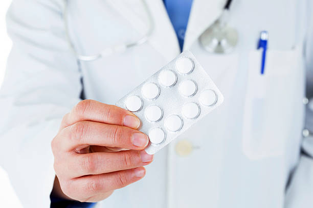 istock doctor holding pills 180805852