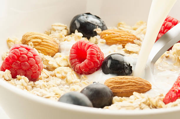 istock Milk pouring over oats, nuts and fresh fruit 180806068