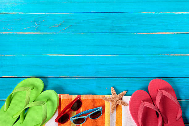 istock Pastel colored beach gear and starfish on blue boardwalk 180806363