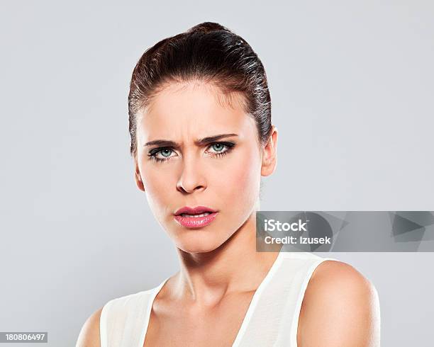 Displeased Young Woman Studio Portrait Stock Photo - Download Image Now - 20-24 Years, Adult, Adults Only