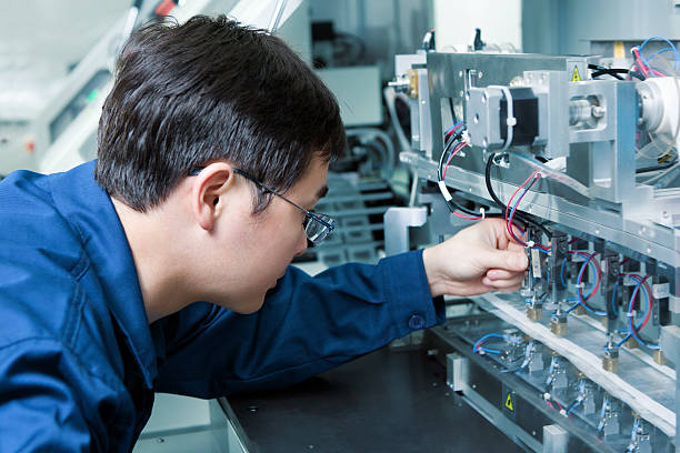 istock An engineer in a blue shirt working closely on electronics 180806555