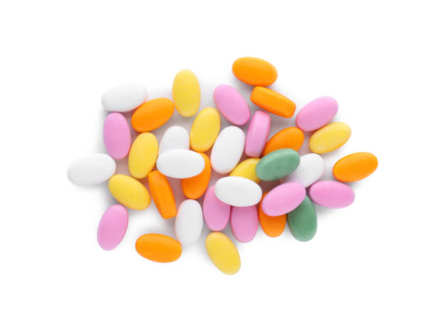 istock Tasty colorful dragee candies on white background, top view 1808066893