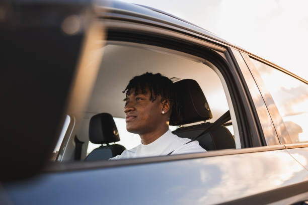 istock Happy Driver at sunset. African American man driving. 1808069532