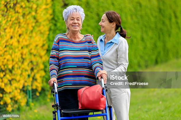 Senior Woman With Walker And Caregiver Stock Photo - Download Image Now - Females, Home Caregiver, A Helping Hand