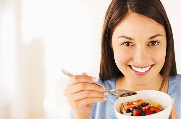 istock Woman Having Cereal With Fresh Fruits 180807027