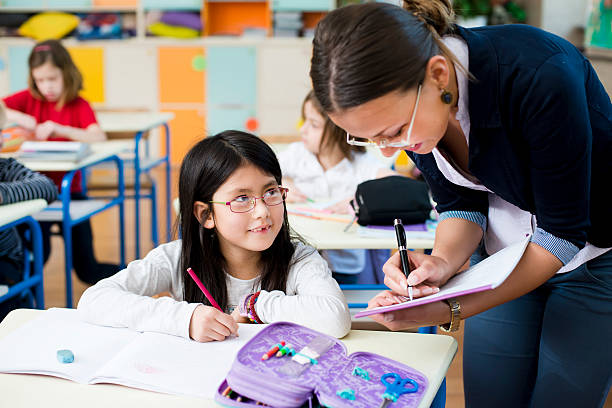 istock Teacher and schoolgirl 180807032