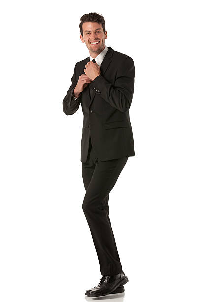 istock Happy businessman adjusting his tie 180807156