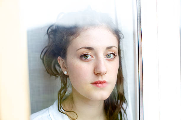 istock Teenage looking through window 180807194