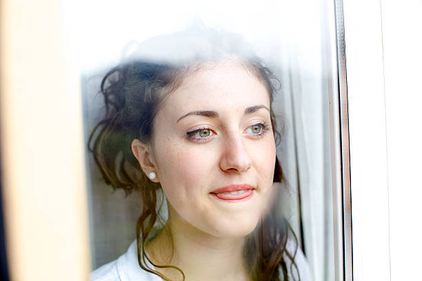 istock Teenage looking through window 180807524