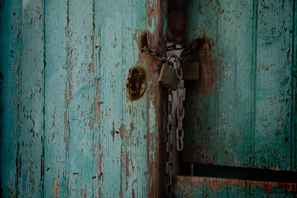 porta turchese molto vecchia, vernice rustica, ingresso rotto, catena e serratura in metallo arrugginito - wood shutter rusty rust foto e immagini stock