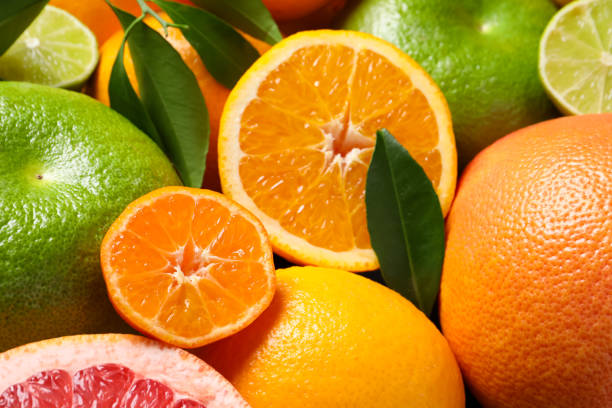 istock Different fresh whole and cut citrus fruits as background 1808076847