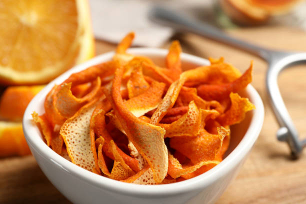 istock Dry orange peels on wooden table, closeup 1808079167