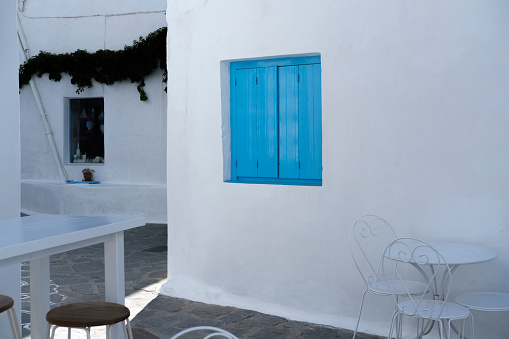 minimalism in greek streets, sophisticated Greece style street cafe, white color, gray, rustic, whitewahsed architecture