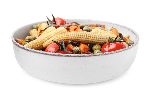 Tasty roasted baby corn with tomatoes and capers isolated on white