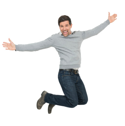 Full length of successful mature man jumping with arms outstretched over white background.