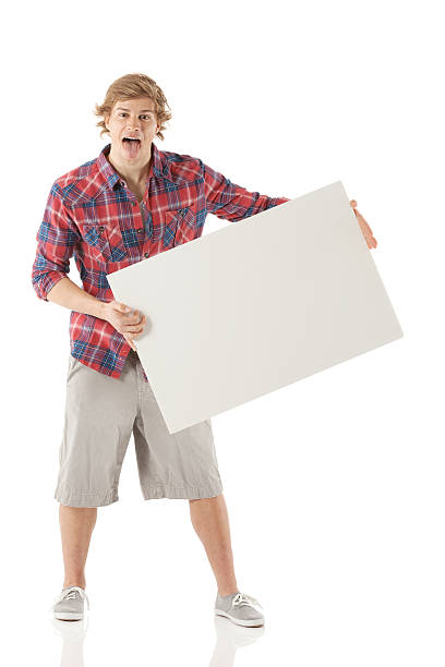 istock Young man holding a blank placard 180808793