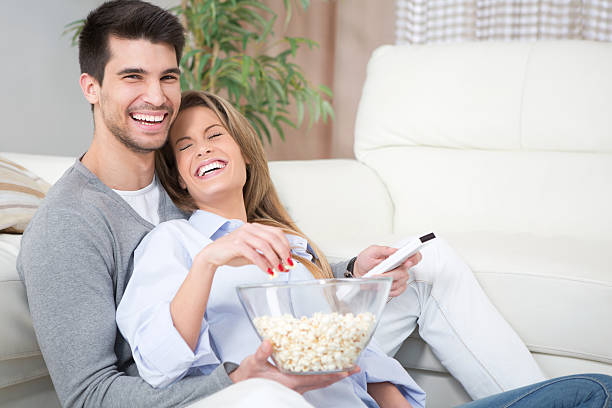 istock Couple at home watching TV. 180809225