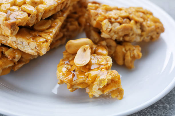 istock Delicious peanut kozinaki bars on white plate, closeup 1808094161