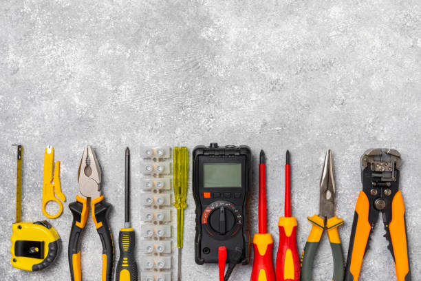 istock Electrician equipment on marble background with copy space.Top view.Electrician tool set.Multimeter, tester,screwdrivers,cutters,duct tape,lamps,tape measure and wires.Flet lay. 1808098539