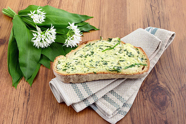 herb butter wild garlic (Allium ursinum) on slice of bread herb butter wild garlic (Allium ursinum) on slice of bread. zigeunerlauch stock pictures, royalty-free photos & images