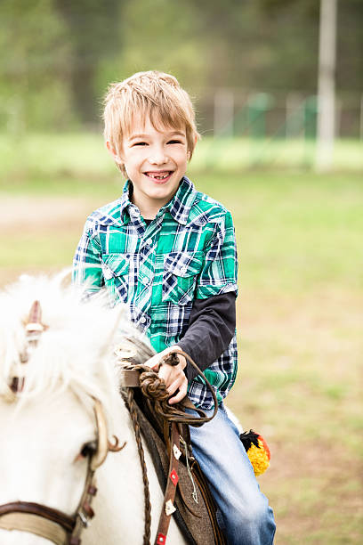 istock Little boy riding a horse 180810010