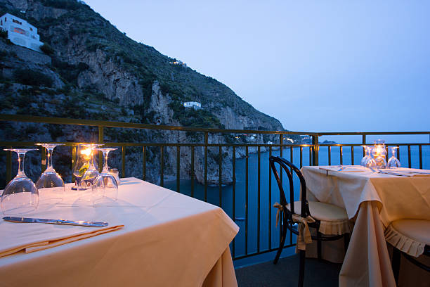 Amalfi Coast in Campania, Italy A restaurant overlooking the Tyrrhenian Sea on the Amalfi Coast praiano photos stock pictures, royalty-free photos & images