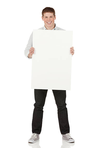 istock Happy young man holding a placard 180810217
