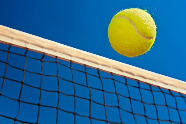 istock Tennis ball and net 180810350