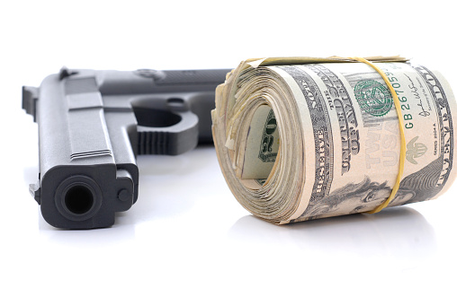 Gun with a roll of money.