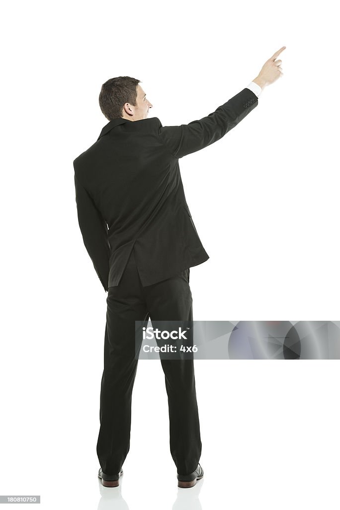 Uomo d'affari in posa di una vista posteriore - Foto stock royalty-free di Abbigliamento elegante